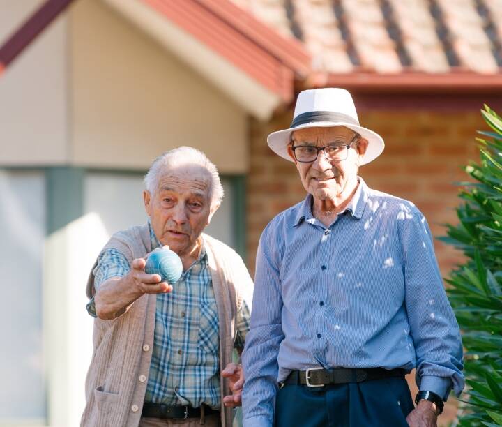 Two residents playing lawn bowls.